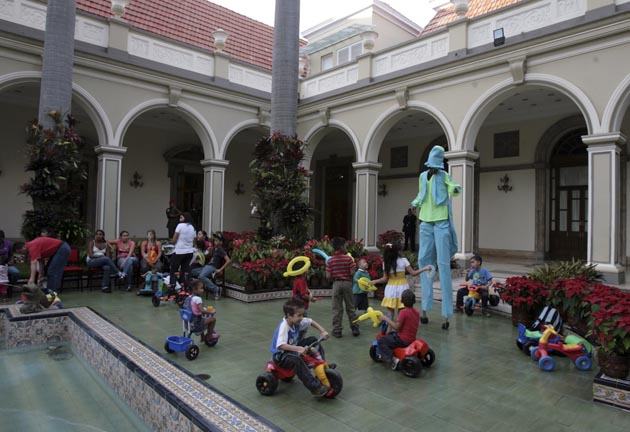 Children of families made displaced due to recent torrential rain play at a section of the Miraflores presidential palace in Caracas