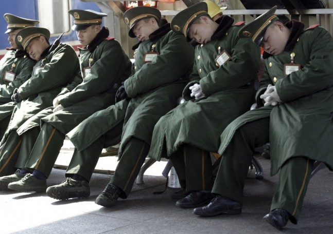 80326-paramilitary-policemen-sleep-at-a-platform-of-the-guangzhou-railway-st