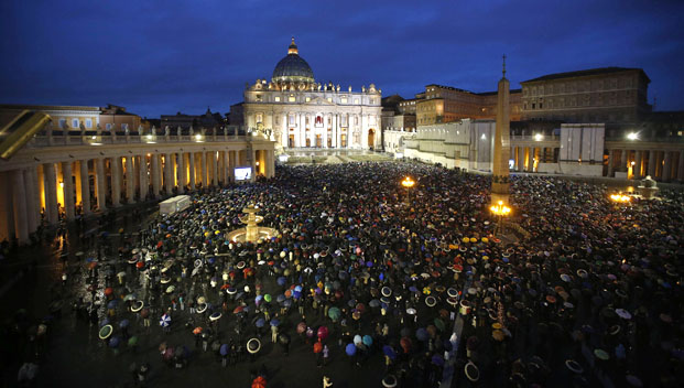 Faithful wait in the rain under umbrellas at Saint Peter's Square at the Vatican
